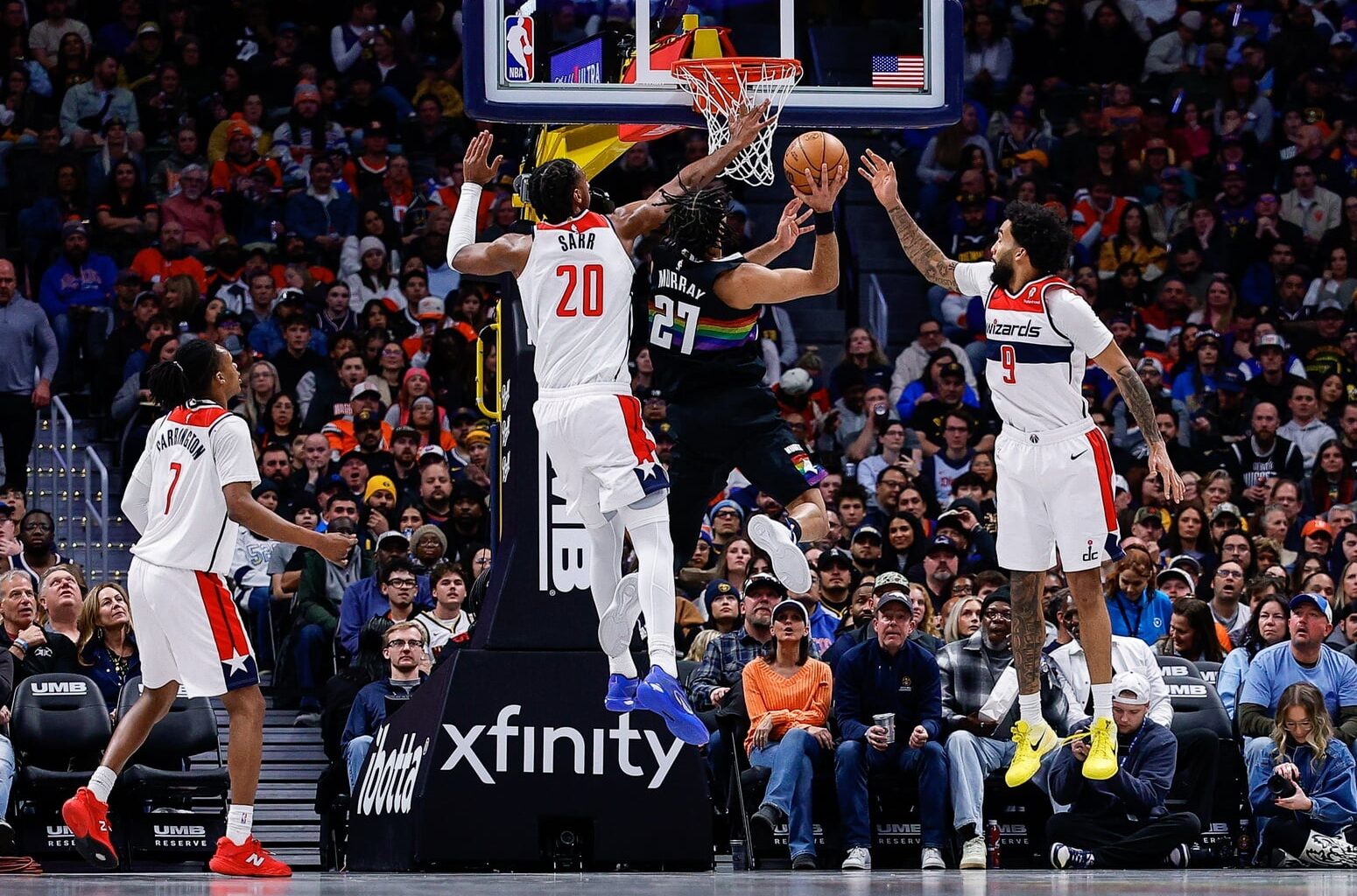 Jan 17, 2026; Denver, Colorado, USA; Denver Nuggets guard Jamal Murray (27) drives to the net against Washington Wizards center Alex Sarr (20) and forward Justin Champagnie (9) in the third quarter at Ball Arena. Mandatory Credit: Isaiah J. Downing-Imagn Images