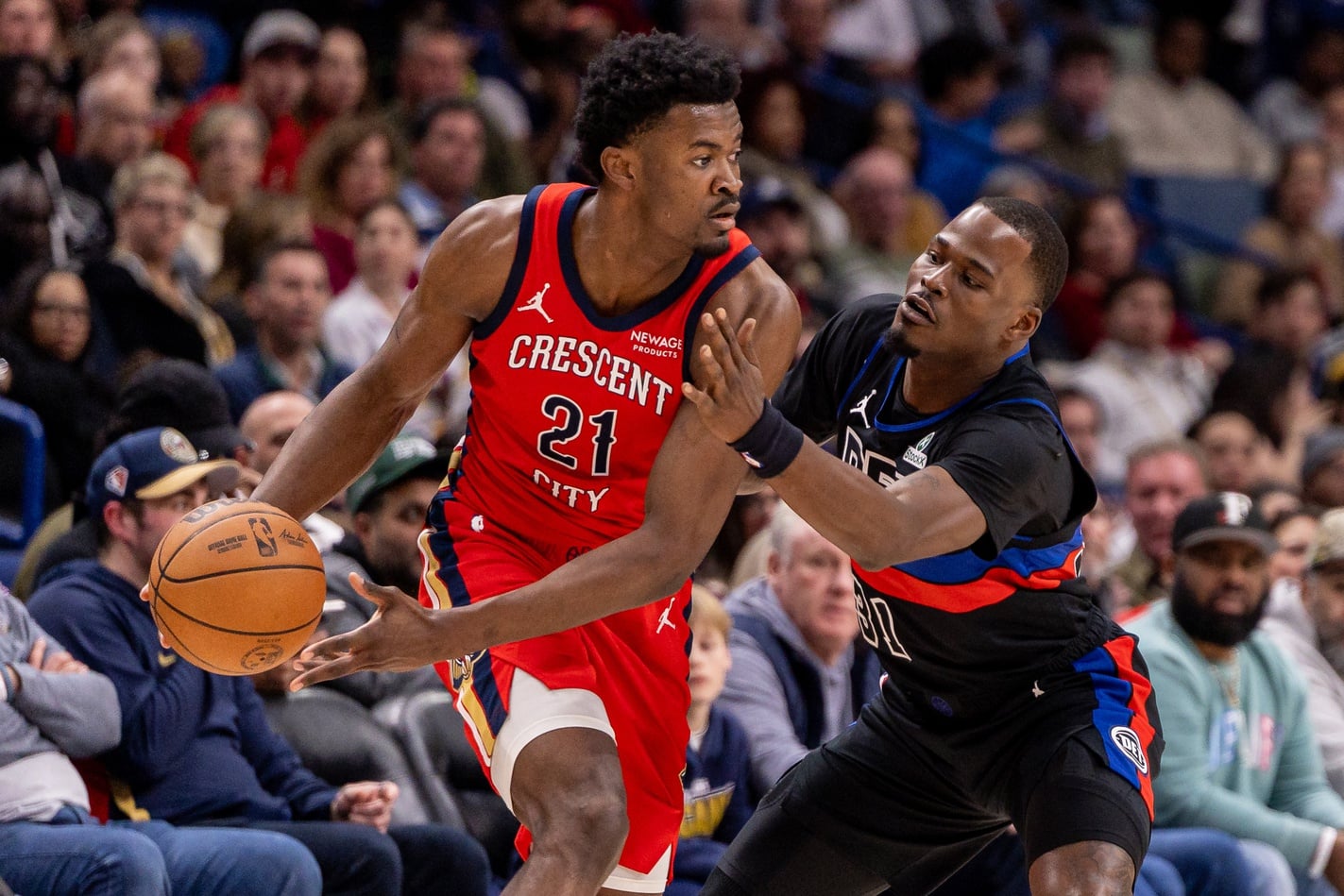New Orleans Pelicans center Yves Missi (21) dribbles against Detroit Pistons guard Javonte Green (31) during the first half at Smoothie King Center.