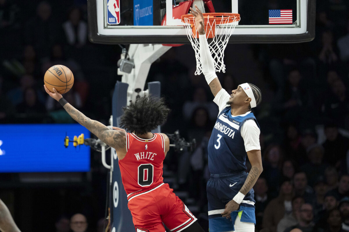 Jan 22, 2026; Minneapolis, Minnesota, USA; Minnesota Timberwolves forward Jaden McDaniels (3) jumps to block as Chicago Bulls guard Coby White (0) drives to the basket at Target Center.