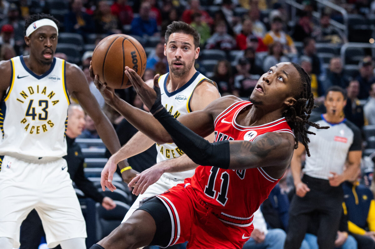 Jan 28, 2026; Indianapolis, Indiana, USA; Chicago Bulls guard Ayo Dosunmu (11) shoots the ball while Indiana Pacers guard T.J. McConnell (9) defends in the first half at Gainbridge Fieldhouse.