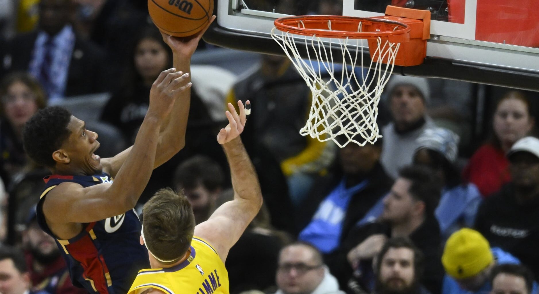 Jan 28, 2026; Cleveland, Ohio, USA; Cleveland Cavaliers forward De'Andre Hunter (12) drives to the basket beside Los Angeles Lakers forward Drew Timme (17) in the fourth quarter at Rocket Arena. Mandatory Credit: David Richard-Imagn Images