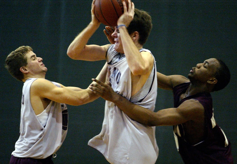 Plano's Matt Riccardi (left) and Brandon Ware (right) try to gain possession of the ball...