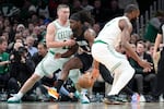 Portland Trail Blazers guard Jrue Holiday (5) drives to the basket against Boston Celtics guard Payton Pritchard (11) during the first half of an NBA basketball game Monday, Jan. 26, 2026, in Boston.
