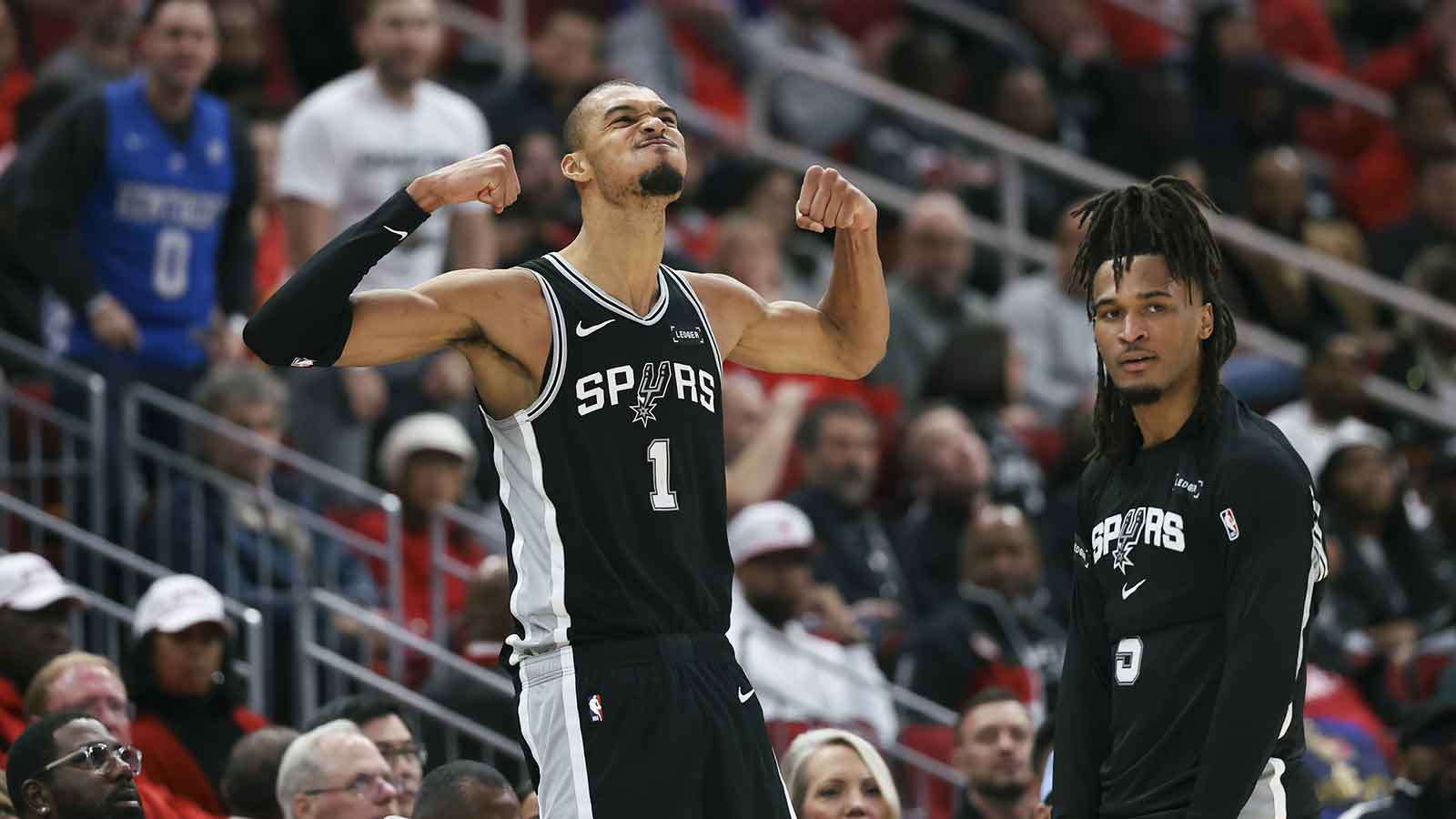 San Antonio Spurs forward Victor Wembanyama (1) and guard Stephon Castle (5) react after a play during the fourth quarter against the Houston Rockets at Toyota Center.