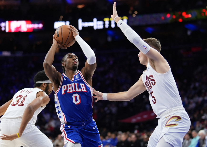Philadelphia 76ers' Tyrese Maxey (0) goes up for a shot against Cleveland Cavaliers' Sam Merrill (5) during the first half of an NBA basketball game Wednesday, Jan. 14, 2026, in Philadelphia.
