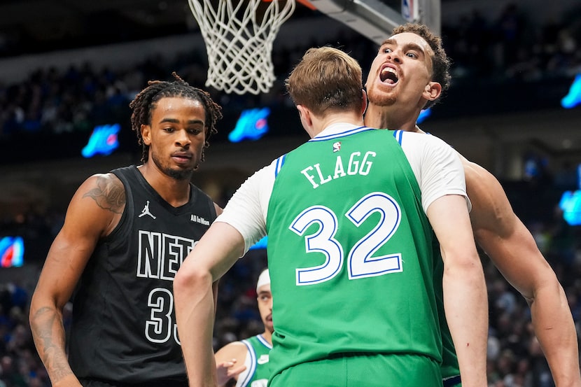 Dallas Mavericks forward Cooper Flagg (32) celebrates with forward Dwight Powell after...