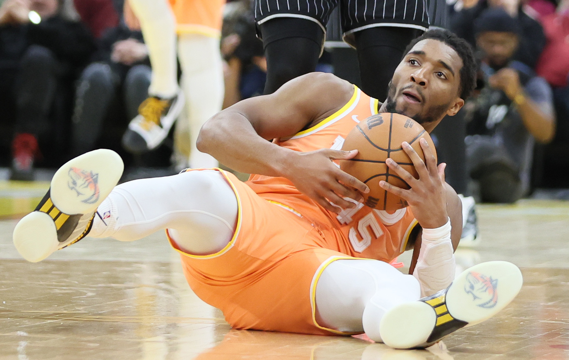 Cleveland Cavaliers guard Donovan Mitchell falls to the court after being fouled by Orlando Magic guard Desmond Bane in the second half. 