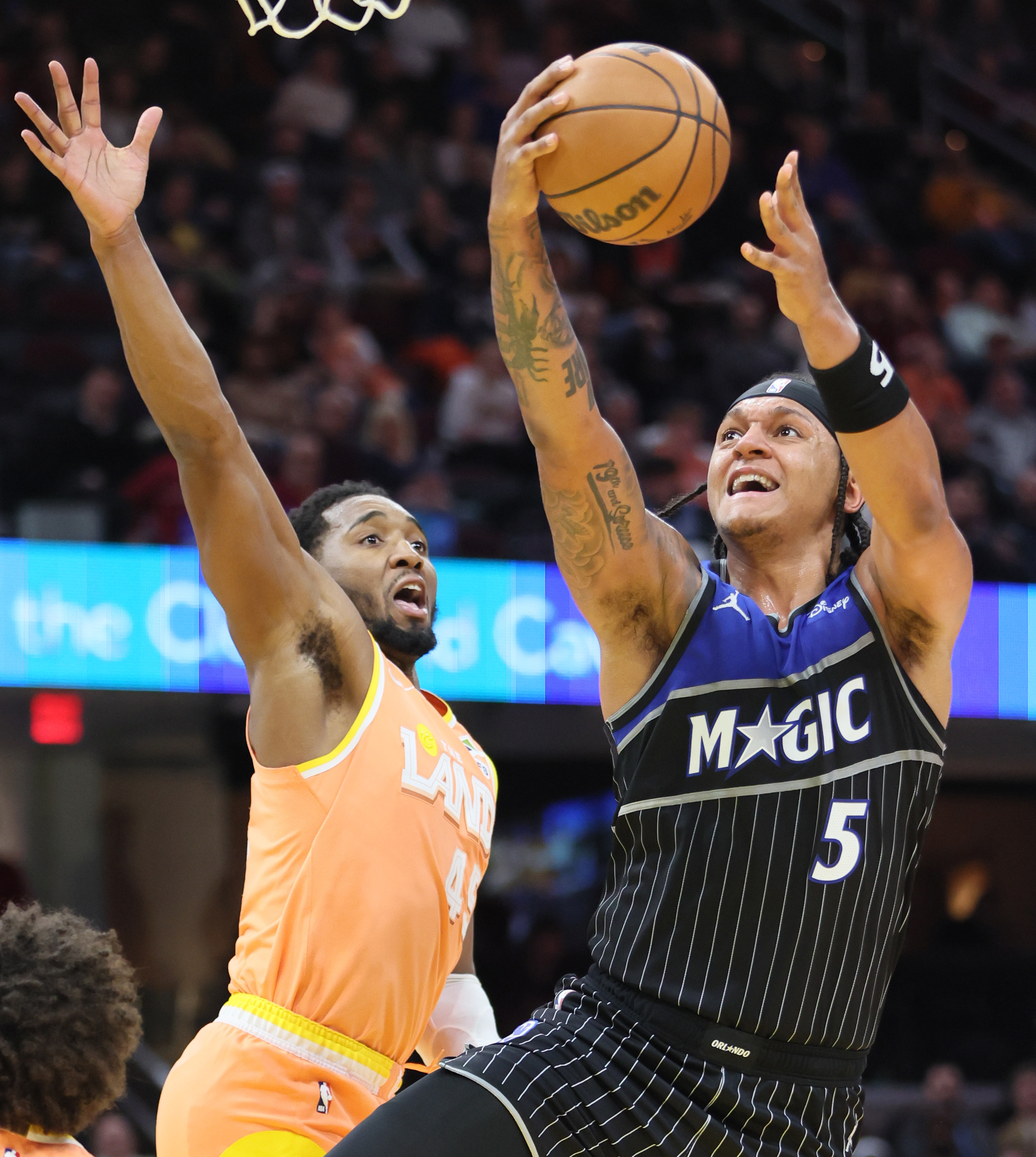 Orlando Magic forward Paolo Banchero drives to the basket for a scorer guarded by Cleveland Cavaliers guard Donovan Mitchell in the second half. 