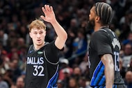 Dallas Mavericks forward Cooper Flagg (32) celebrates with forward Naji Marshall (13) during...