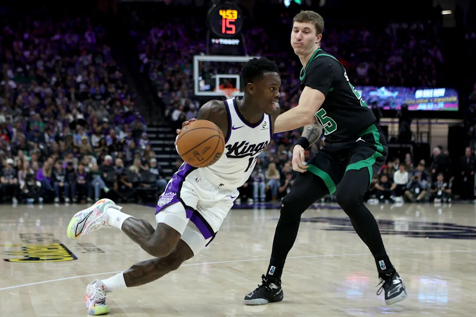 Jan 1, 2026; Sacramento, California, USA; Sacramento Kings guard Dennis Schroder (17) controls the ball while being defended by Boston Celtics guard Baylor Scheierman (55) during the third quarter at Golden 1 Center. Mandatory Credit: Dennis Lee-Imagn Images