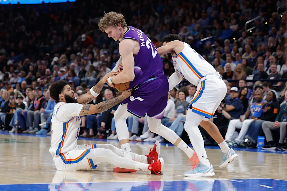 Jan 7, 2026; Oklahoma City, Oklahoma, USA; Utah Jazz forward/center Lauri Markkanen (23) fights for control of the ball with Oklahoma City Thunder guard/forward Kenrich Williams (34) and guard Ajay Mitchell (25) during the second half at Paycom Center. Mandatory Credit: Alonzo Adams-Imagn Images