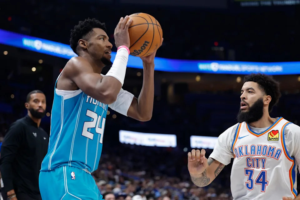 Jan 5, 2026; Oklahoma City, Oklahoma, USA; Charlotte Hornets forward Brandon Miller (24) shoots a three point basket against Oklahoma City Thunder guard Kenrich Williams (34) during the second half at Paycom Center. Mandatory Credit: Alonzo Adams-Imagn Images