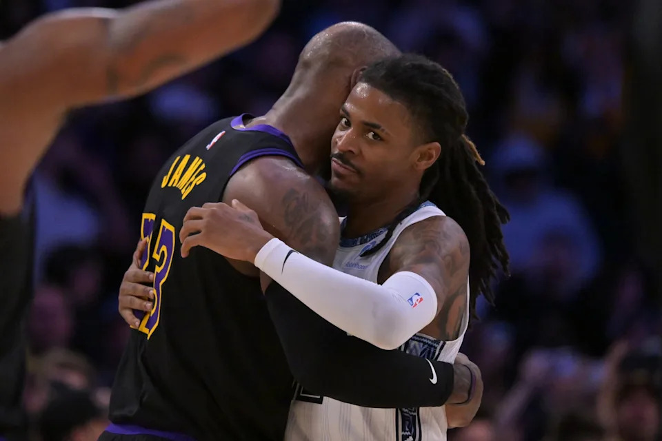 Los Angeles Lakers forward LeBron James (23) and Memphis Grizzlies guard Ja Morant (12) embrace following the game at Crypto.com Arena in Los Angeles, California on Jan. 2, 2026.