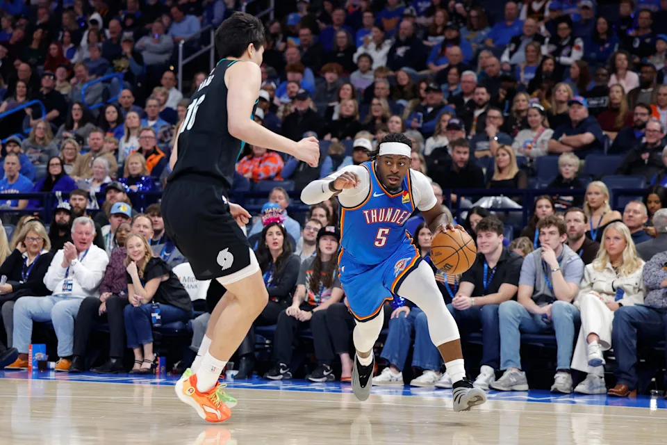 Dec 31, 2025; Oklahoma City, Oklahoma, USA; Oklahoma City Thunder guard Luguentz Dort (5) drives to the basket around Portland Trail Blazers center Yang Hansen (16) during the second half at Paycom Center. Mandatory Credit: Alonzo Adams-Imagn Images