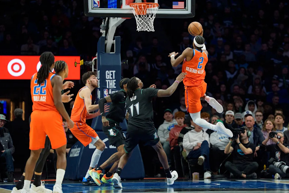 Jan 29, 2026; Minneapolis, Minnesota, USA; Oklahoma City Thunder guard Shai Gilgeous-Alexander (2) shoots over Minnesota Timberwolves center Naz Reid (11) in the second quarter at Target Center. Mandatory Credit: Matt Blewett-Imagn Images