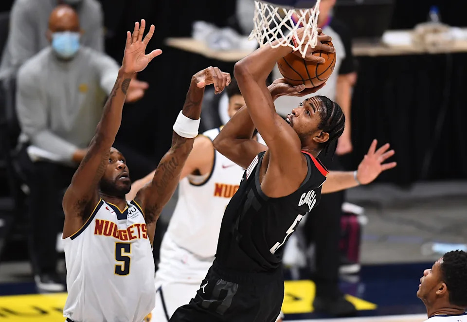 Dec 28, 2020; Denver, Colorado, USA; Houston Rockets forward Bruno Caboclo (5) shoots the ball over Denver Nuggets guard Will Barton (5) in the second half at Ball Arena. Mandatory Credit: Ron Chenoy-USA TODAY Sports