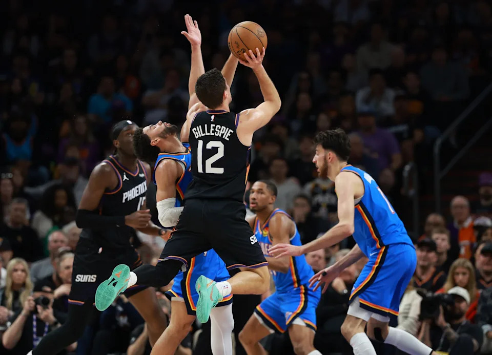 Jan 4, 2026; Phoenix, Arizona, USA; Phoenix Suns guard Collin Gillespie (12) shoots the ball against the Oklahoma City Thunder in the first half at Mortgage Matchup Center. Mandatory Credit: Mark J. Rebilas-Imagn Images