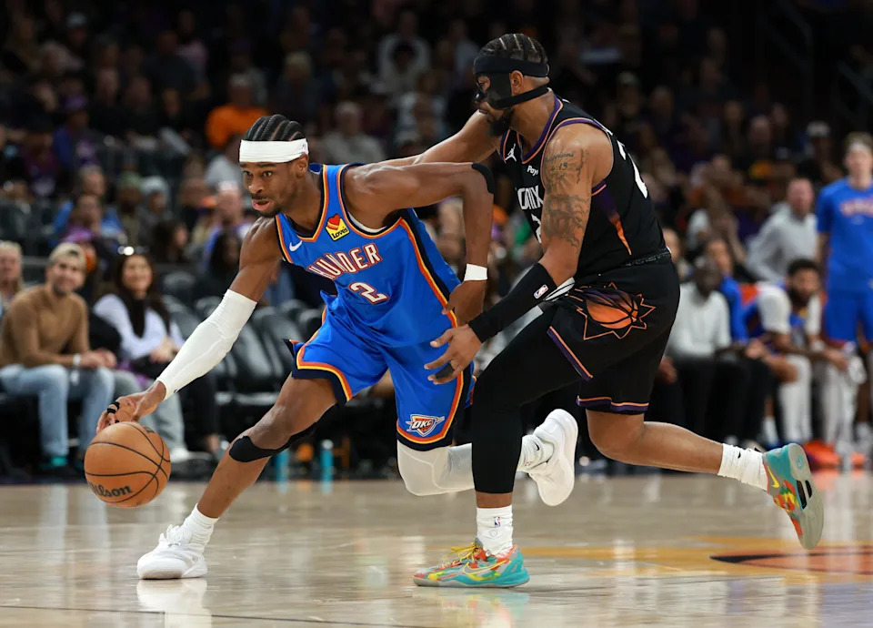 Jan 4, 2026; Phoenix, Arizona, USA; Oklahoma City Thunder guard Shai Gilgeous-Alexander (2) against Phoenix Suns guard Jordan Goodwin in the first half at Mortgage Matchup Center. Mandatory Credit: Mark J. Rebilas-Imagn Images
