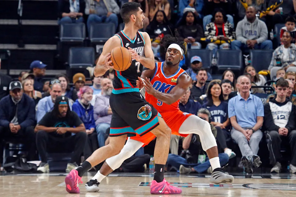 Jan 9, 2026; Memphis, Tennessee, USA; Memphis Grizzlies forward Santi Aldama (7) handles the ball as Oklahoma City Thunder guard Luguentz Dort (5) defends during the second quarter at FedExForum. Mandatory Credit: Petre Thomas-Imagn Images