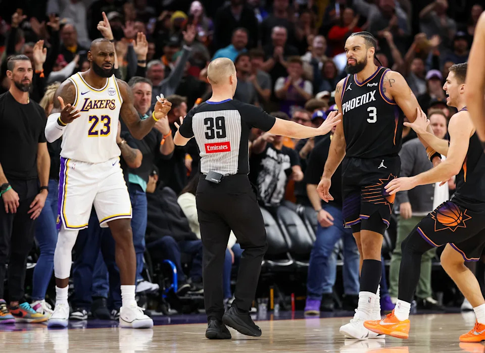 PHOENIX, ARIZONA – DECEMBER 14: Referee Tyler Ford #39 gets between Lebron James #23 of the Los Angeles Lakers and Dillon Brooks #3 of the Phoenix Suns after a foul by Brooks during the second half of a game at Mortgage Matchup Center on December 14, 2025 in Phoenix, Arizona. NOTE TO USER: User expressly acknowledges and agrees that, by downloading and or using this photograph, User is consenting to the terms and conditions of the Getty Images License Agreement. (Photo by Mike Christy/Getty Images)