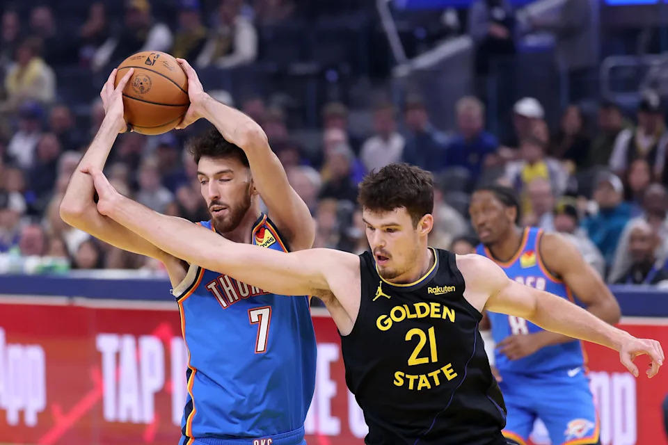 SAN FRANCISCO, CALIFORNIA - JANUARY 02: Chet Holmgren #7 of the Oklahoma City Thunder and Quinten Post #21 of the Golden State Warriors go for a rebound during the first quarter at Chase Center on January 02, 2026 in San Francisco, California. NOTE TO USER: User expressly acknowledges and agrees that, by downloading and/or using this photograph, user is consenting to the terms and conditions of the Getty Images License Agreement. (Photo by Ezra Shaw/Getty Images)