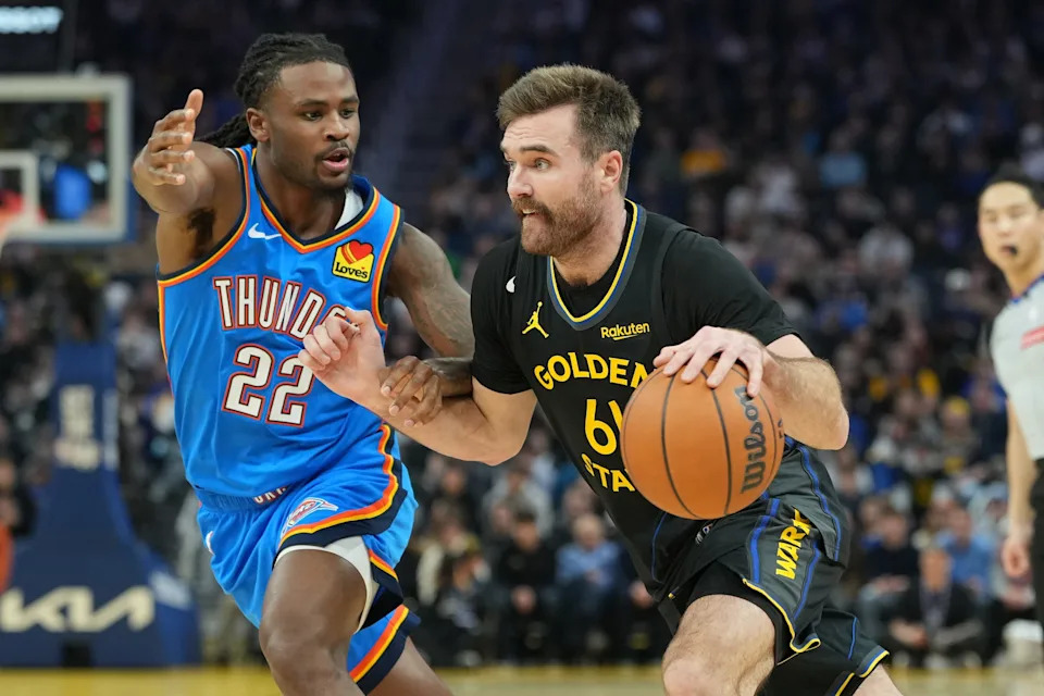 Jan 2, 2026; San Francisco, California, USA; Golden State Warriors guard Pat Spencer (61) dribbles against Oklahoma City Thunder guard Cason Wallace (22) during the second quarter at Chase Center. Mandatory Credit: Darren Yamashita-Imagn Images