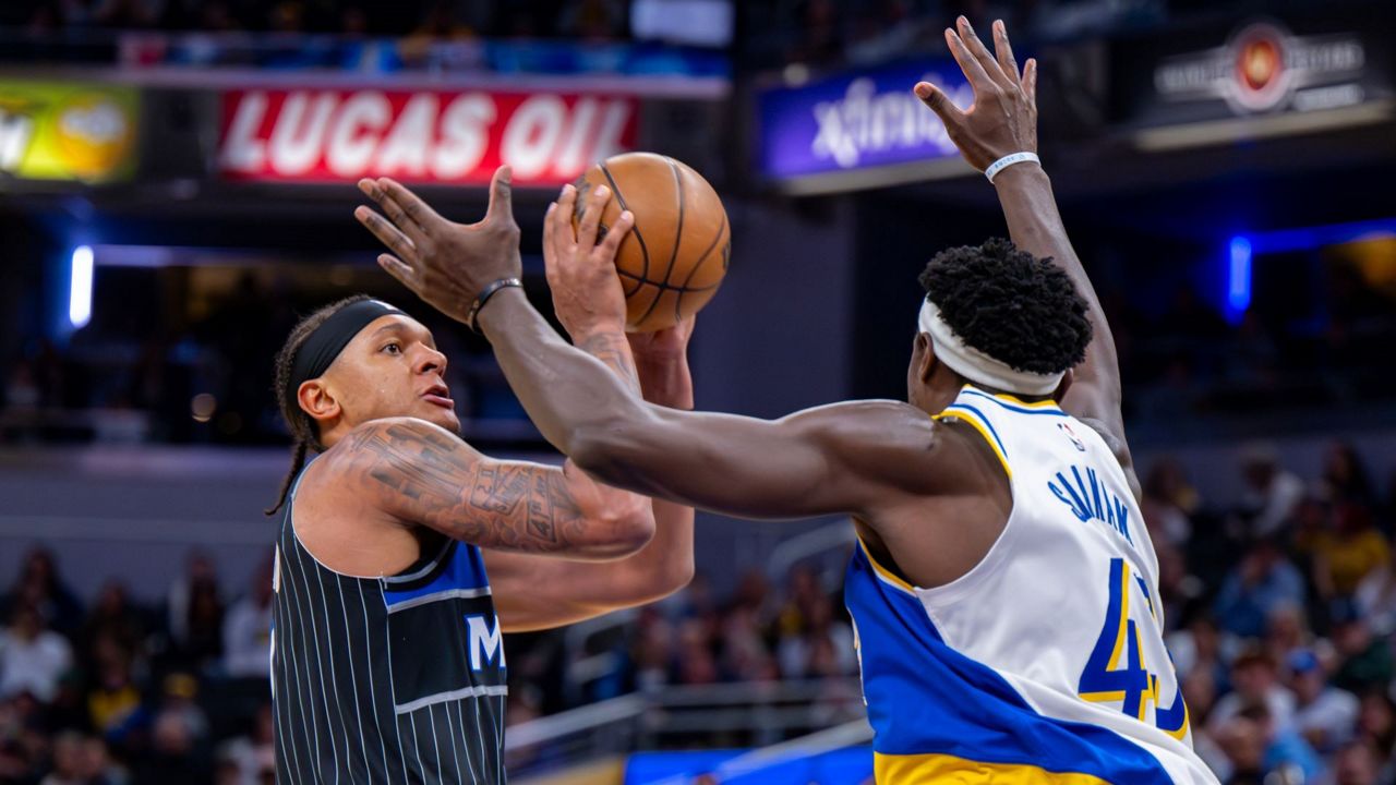 Orlando Magic forward Paolo Banchero shoots while being defended by Indiana Pacers forward Pascal Siakam, left, during the second half of an NBA basketball game in Indianapolis, Wednesday, Dec. 31, 2025. (AP Photo/Doug McSchooler)