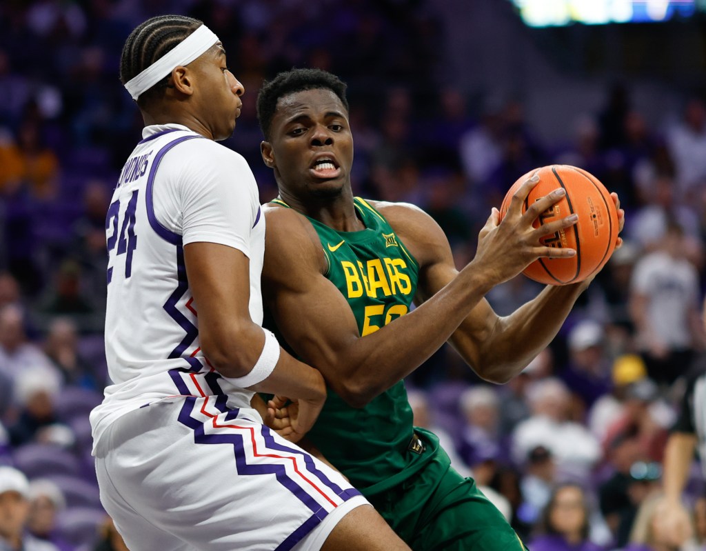 Baylor center James Nnaji (50) battles for position against TCU forward Xavier Edmonds (24).