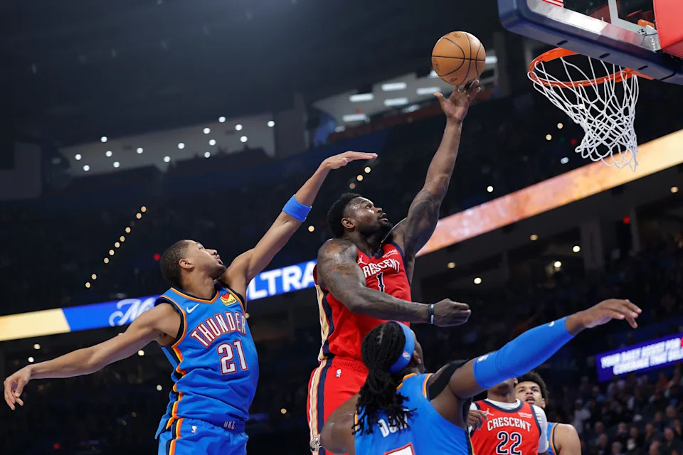 Jan 27, 2026; Oklahoma City, Oklahoma, USA; New Orleans Pelicans forward Zion Williamson (1) goes up for a basket between Oklahoma City Thunder guard Aaron Wiggins (21) and guard Luguentz Dort (5) during the second quarter at Paycom Center. Mandatory Credit: Alonzo Adams-Imagn Images