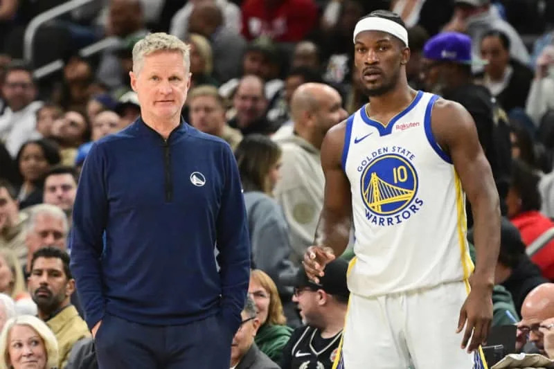 Oct 30, 2025; Milwaukee, Wisconsin, USA; Golden State Warriors head coach Steve Kerr and forward Jimmy Butler (10) looks on during a timeout in the second quarter against the Milwaukee Bucks at Fiserv Forum. Mandatory Credit: Benny Sieu-Imagn Images