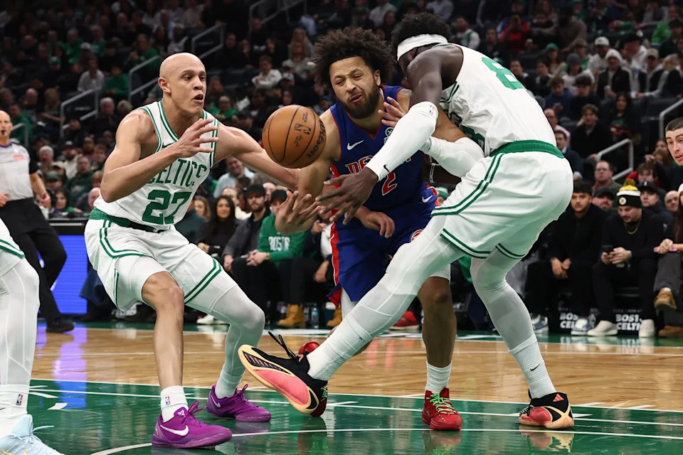Dec 15, 2025; Boston, Massachusetts, USA; Detroit Pistons guard Cade Cunningham (2) looses the ball trying to go between Boston Celtics guard Jordan Walsh (27) and center Neemias Queta (88) during the first quarter at TD Garden. Mandatory Credit: Winslow Townson-Imagn Images