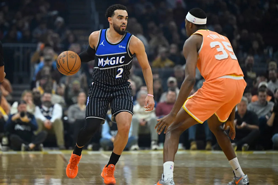 Jan 26, 2026; Cleveland, Ohio, USA; Orlando Magic guard Tyus Jones (2) brings the ball up court beside Cleveland Cavaliers forward Nae'Qwan Tomlin (35) in the first quarter at Rocket Arena. Mandatory Credit: David Richard-Imagn Images