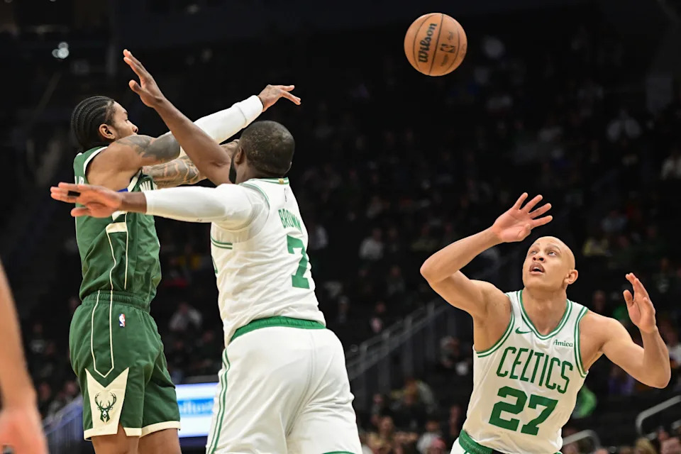Dec 11, 2025; Milwaukee, Wisconsin, USA; Milwaukee Bucks guard Kevin Porter (7) passes the ball away from Boston Celtics forward Jaylen Brown (7) and forward Jordan Walsh (27) in the first quarter at Fiserv Forum. Mandatory Credit: Benny Sieu-Imagn Images