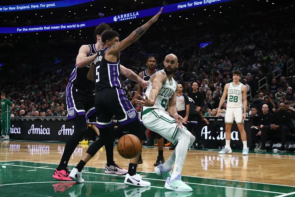 Jan 30, 2026; Boston, Massachusetts, USA; Boston Celtics guard Derrick White (9) passes past Sacramento Kings guard Nique Clifford (5) during the second half at TD Garden. Mandatory Credit: Winslow Townson-Imagn Images