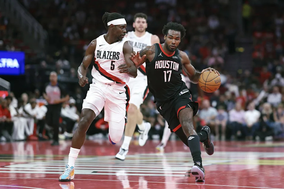Nov 14, 2025; Houston, Texas, USA; Houston Rockets forward Tari Eason (17) drives with the ball as Portland Trail Blazers guard Jrue Holiday (5) defends during the second quarter at Toyota Center. Mandatory Credit: Troy Taormina-Imagn Images