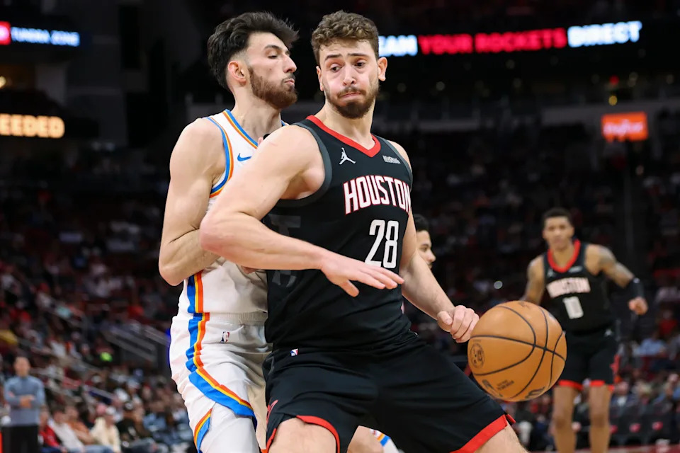 Jan 15, 2026; Houston, Texas, USA; Houston Rockets center Alperen Sengun (28) attempts to dribble the ball around Oklahoma City Thunder center Chet Holmgren (7) during the second quarter at Toyota Center. Mandatory Credit: Troy Taormina-Imagn Images