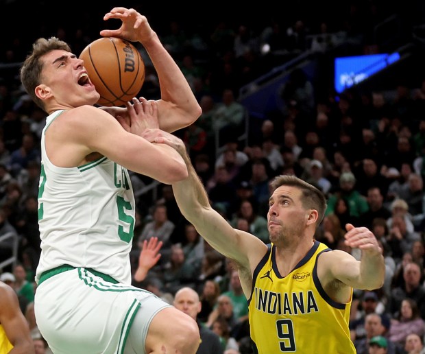Indiana Pacers guard T.J. McConnell (9) fouls Boston Celtics center Luka Garza during the first half of the NBA game at the TD Garden. (Photo By Matt Stone/Boston Herald)