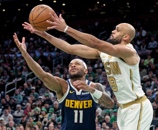 Denver Nuggets guard Bruce Brown (11) and Boston Celtics guard Derrick White (9) rebound during the second half at TD Garden. (Photo By Matt Stone/Boston Herald)