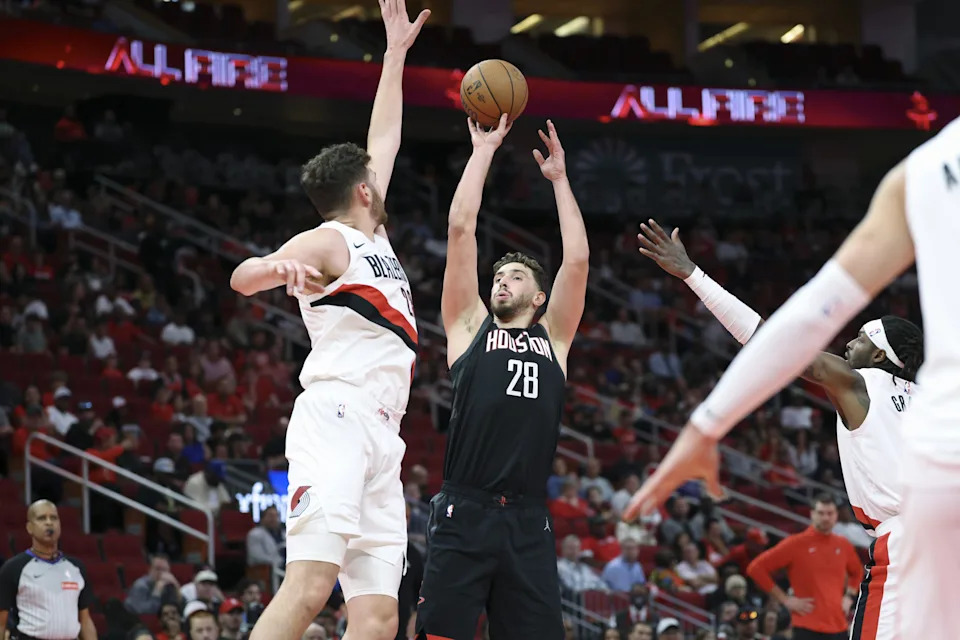 Nov 14, 2025; Houston, Texas, USA; Houston Rockets center Alperen Sengun (28) shoots the ball as Portland Trail Blazers center Donovan Clingan (23) defends during the first quarter at Toyota Center. Mandatory Credit: Troy Taormina-Imagn Images