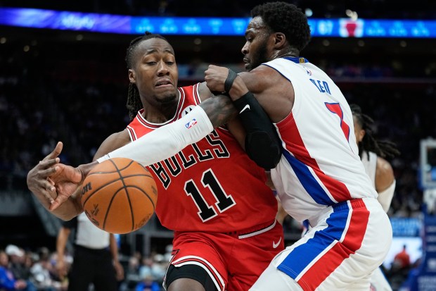 Chicago Bulls guard Ayo Dosunmu, left, is defended by Detroit Pistons forward Paul Reed during the second half of an NBA basketball game Wednesday, Jan. 7, 2026, in Detroit. (AP Photo/Ryan Sun)