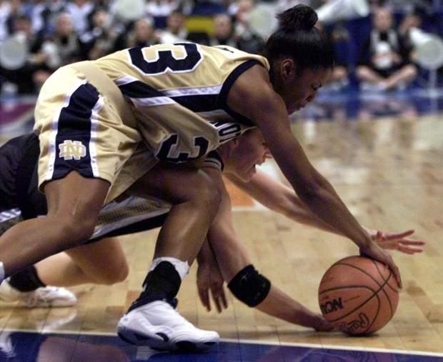 Purdue's Katie Douglas ends up on the bottom of a battle with Notre Dame's Niele Ivey for a loose ball during the NCAA Women's Championship in St. Louis on Sunday, April 1, 2001. (Jay L. Clendenin/The Hartford Courant)