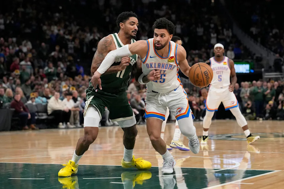 MILWAUKEE, WISCONSIN - JANUARY 21: Ajay Mitchell #25 of the Oklahoma City Thunder dribbles the ball against Gary Harris #11 of the Milwaukee Bucks during the first quarter at Fiserv Forum on January 21, 2026 in Milwaukee, Wisconsin. NOTE TO USER: User expressly acknowledges and agrees that, by downloading and or using this photograph, User is consenting to the terms and conditions of the Getty Images License Agreement. (Photo by Patrick McDermott/Getty Images)