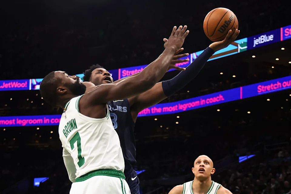 Nov 12, 2025; Boston, Massachusetts, USA; Memphis Grizzlies forward Jaren Jackson Jr. (8) goes to the basket against Boston Celtics guard Jaylen Brown (7) during the second quarter at TD Garden. Mandatory Credit: Winslow Townson-Imagn Images