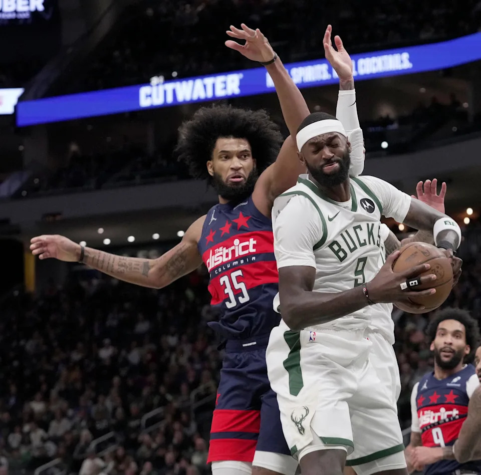 Bucks forward Bobby Portis grabs a rebound in front of Wizards forward Marvin Bagley III during the first half of their game Dec. 31 at Fiserv Forum.