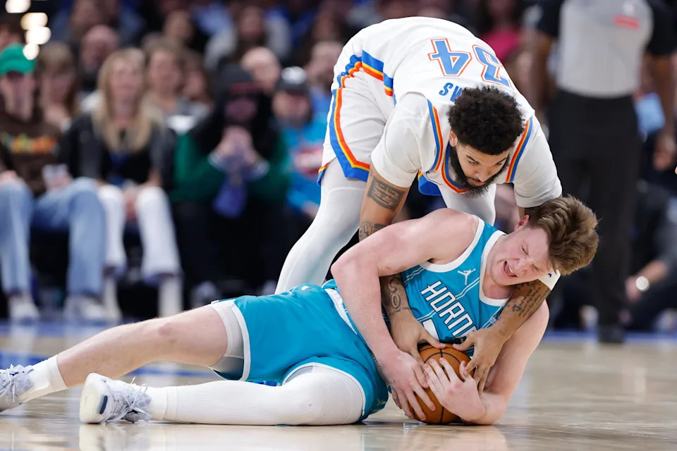 Jan 5, 2026; Oklahoma City, Oklahoma, USA; Oklahoma City Thunder guard Kenrich Williams (34) and Charlotte Hornets guard Kon Knueppel (7) fight for a loose ball during the second half at Paycom Center. Mandatory Credit: Alonzo Adams-Imagn Images