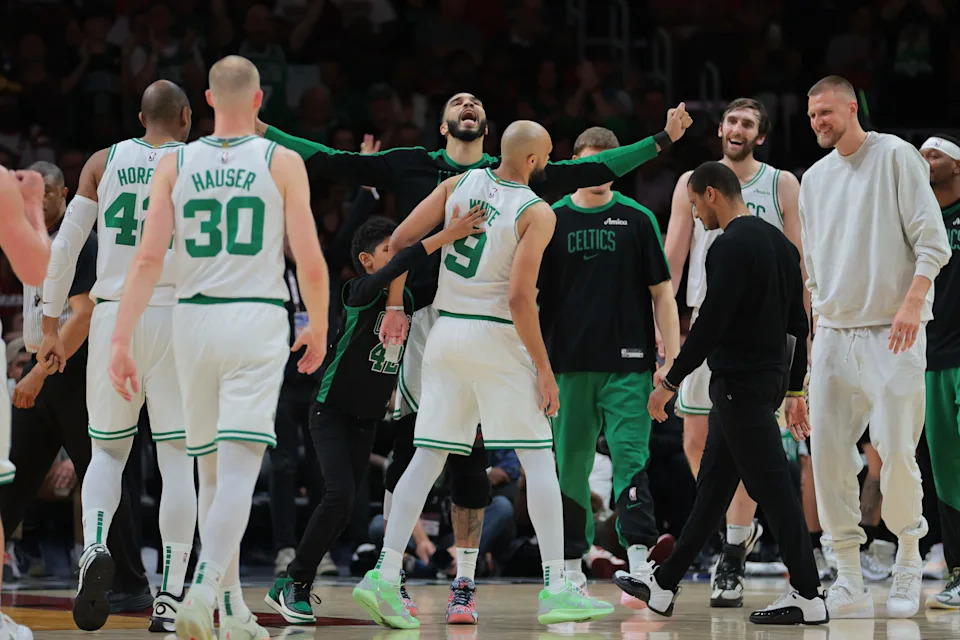 Mar 14, 2025; Miami, Florida, USA; Boston Celtics forward Jayson Tatum (0) celebrates with guard Derrick White (9) against the Miami Heat during the fourth quarter at Kaseya Center. Mandatory Credit: Sam Navarro-Imagn Images