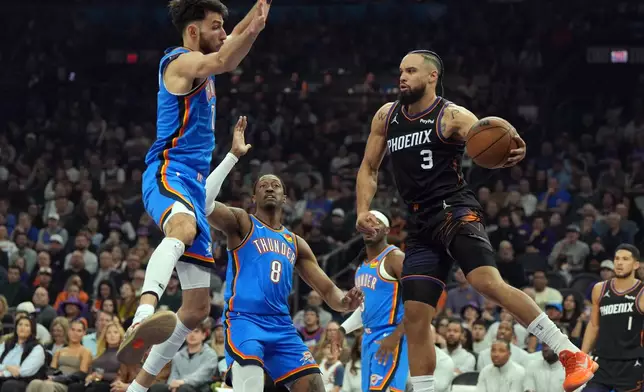 Phoenix Suns forward Dillon Brooks (3) drives against Oklahoma City Thunder center Chet Holmgren, left, and guard Jalen Williams (8) during the first half of an NBA basketball game, Sunday, Jan. 4, 2026, in Phoenix. (AP Photo/Rick Scuteri)