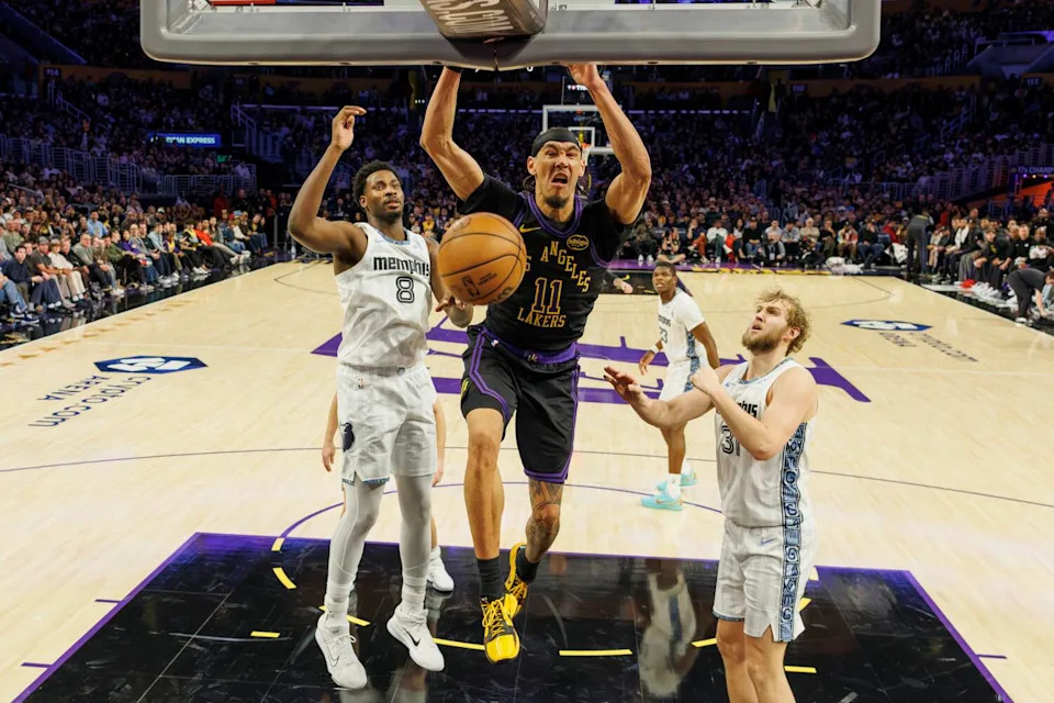 Lakers center Jaxson Hayes dunks over Memphis Grizzlies forward Jaren Jackson Jr. and center Jock Landale.