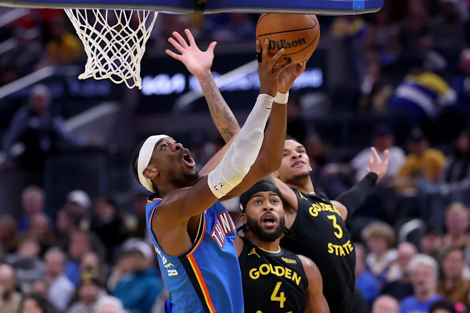 SAN FRANCISCO, CALIFORNIA - JANUARY 02: Shai Gilgeous-Alexander #2 of the Oklahoma City Thunder goes up for a shot against Moses Moody #4 and Will Richard #3 of the Golden State Warriors during the second half at Chase Center on January 02, 2026 in San Francisco, California. NOTE TO USER: User expressly acknowledges and agrees that, by downloading and/or using this photograph, user is consenting to the terms and conditions of the Getty Images License Agreement. (Photo by Ezra Shaw/Getty Images)
