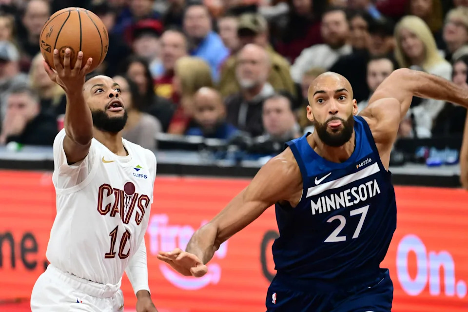 Jan 10, 2026; Cleveland, Ohio, USA; Cleveland Cavaliers guard Darius Garland (10) drives to the basket against Minnesota Timberwolves center Rudy Gobert (27) during the first half at Rocket Arena. Mandatory Credit: Ken Blaze-Imagn Images
